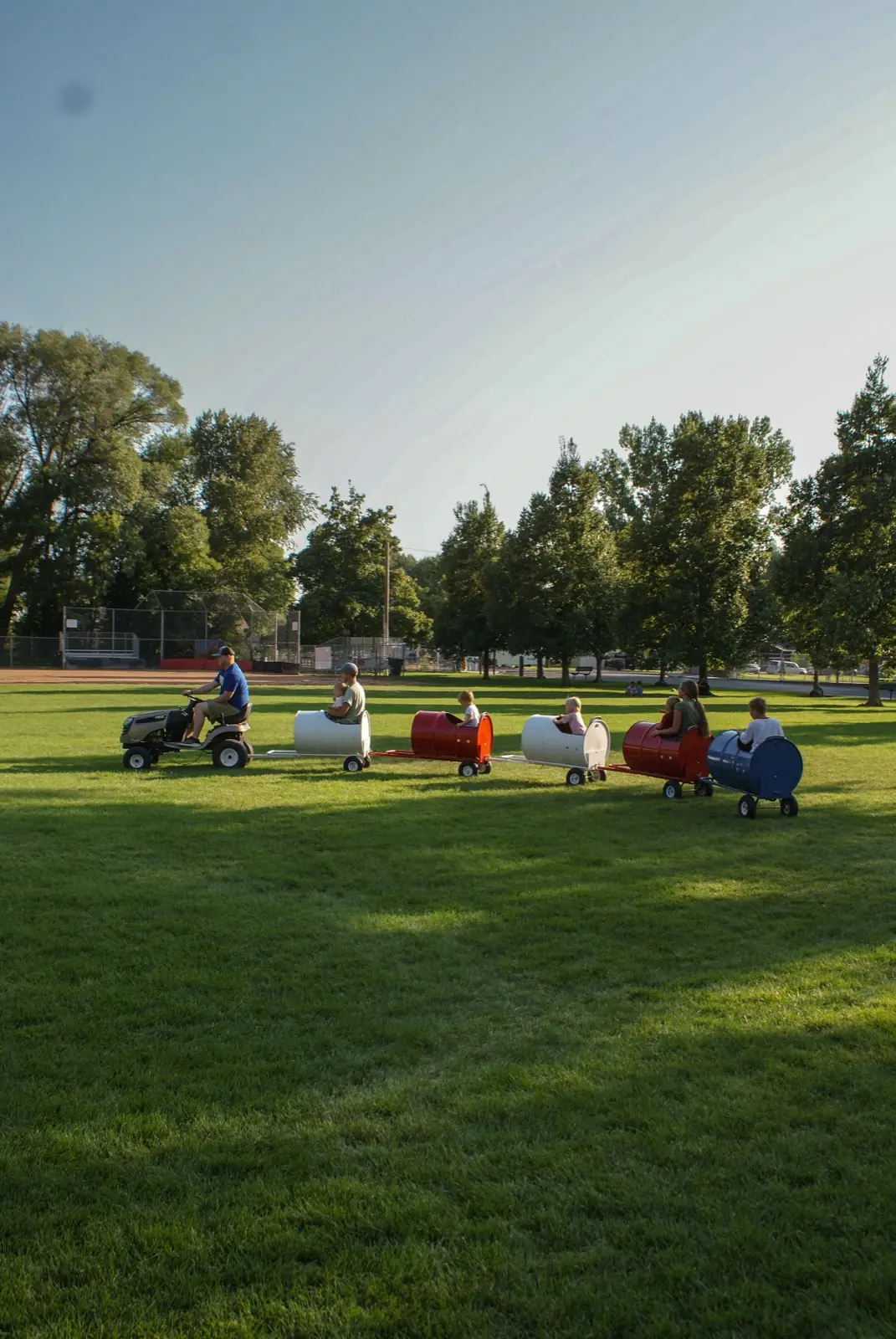 Kids riding the Backyard Barrel Express barrel train