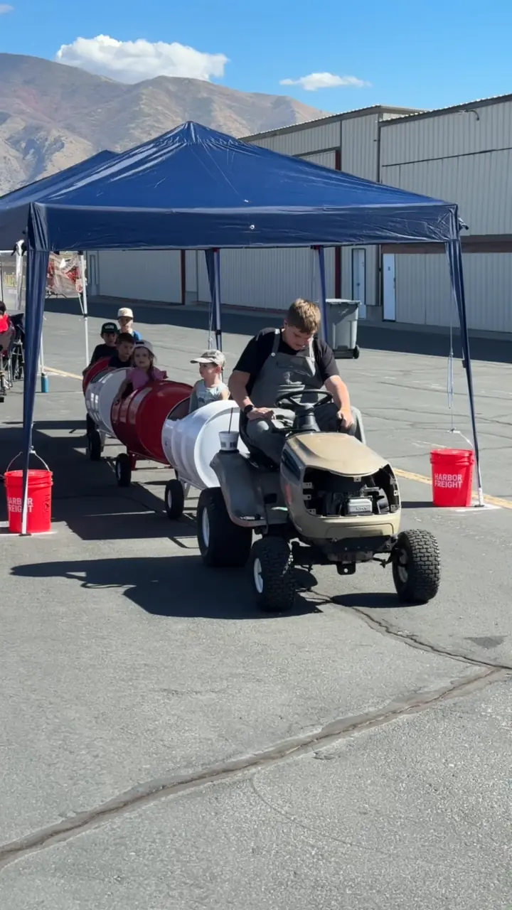 Video of kids riding the barrel train under the tent at the airshow