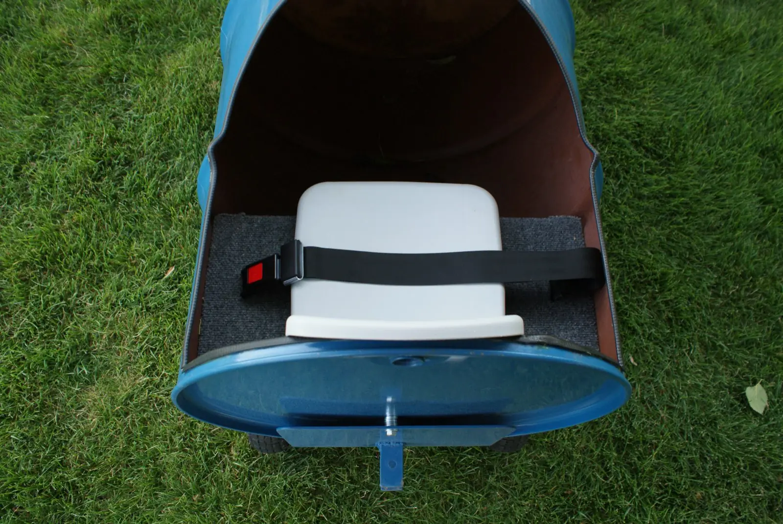 Inside a barrel car: cushioned seat and safety belt