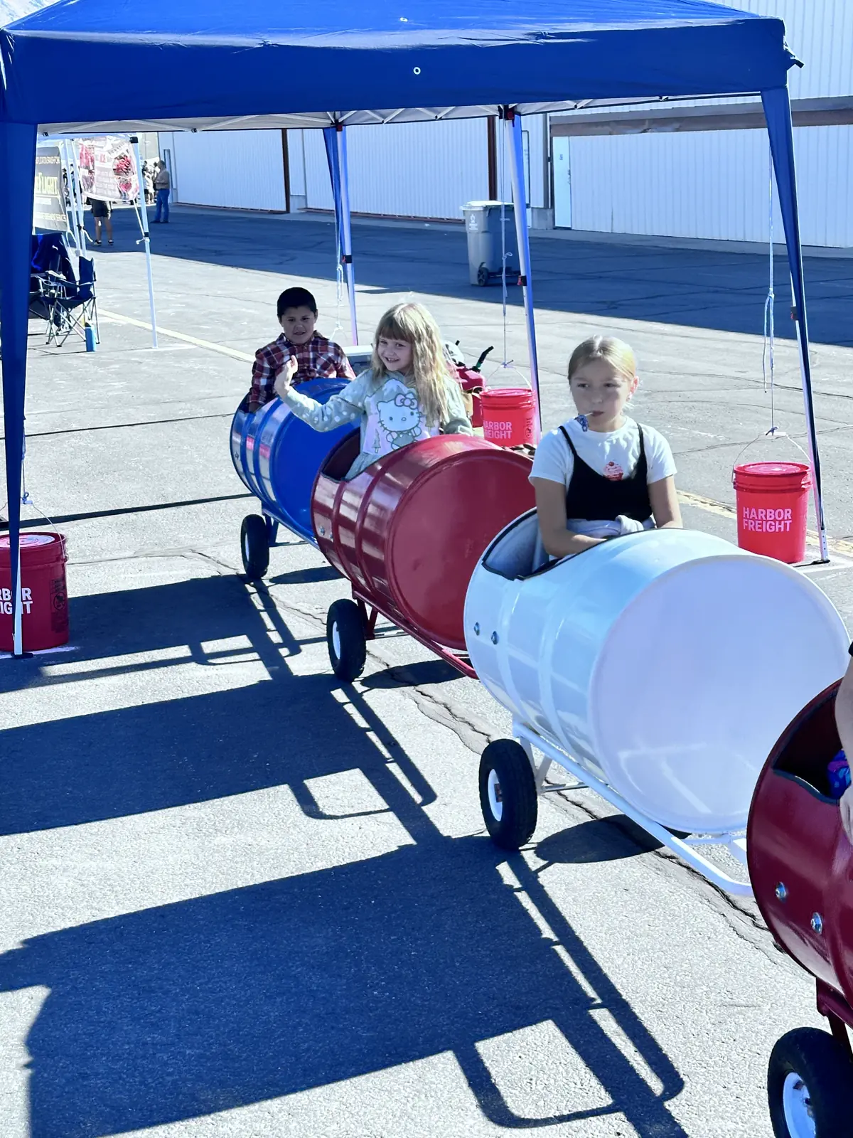 Kids riding the barrel train at the airshow