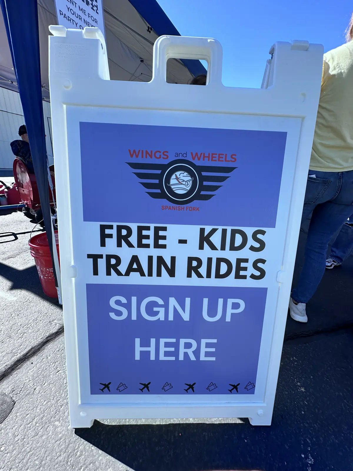 A 'Free Kids Train Rides' sign at the Wings & Wheels airshow