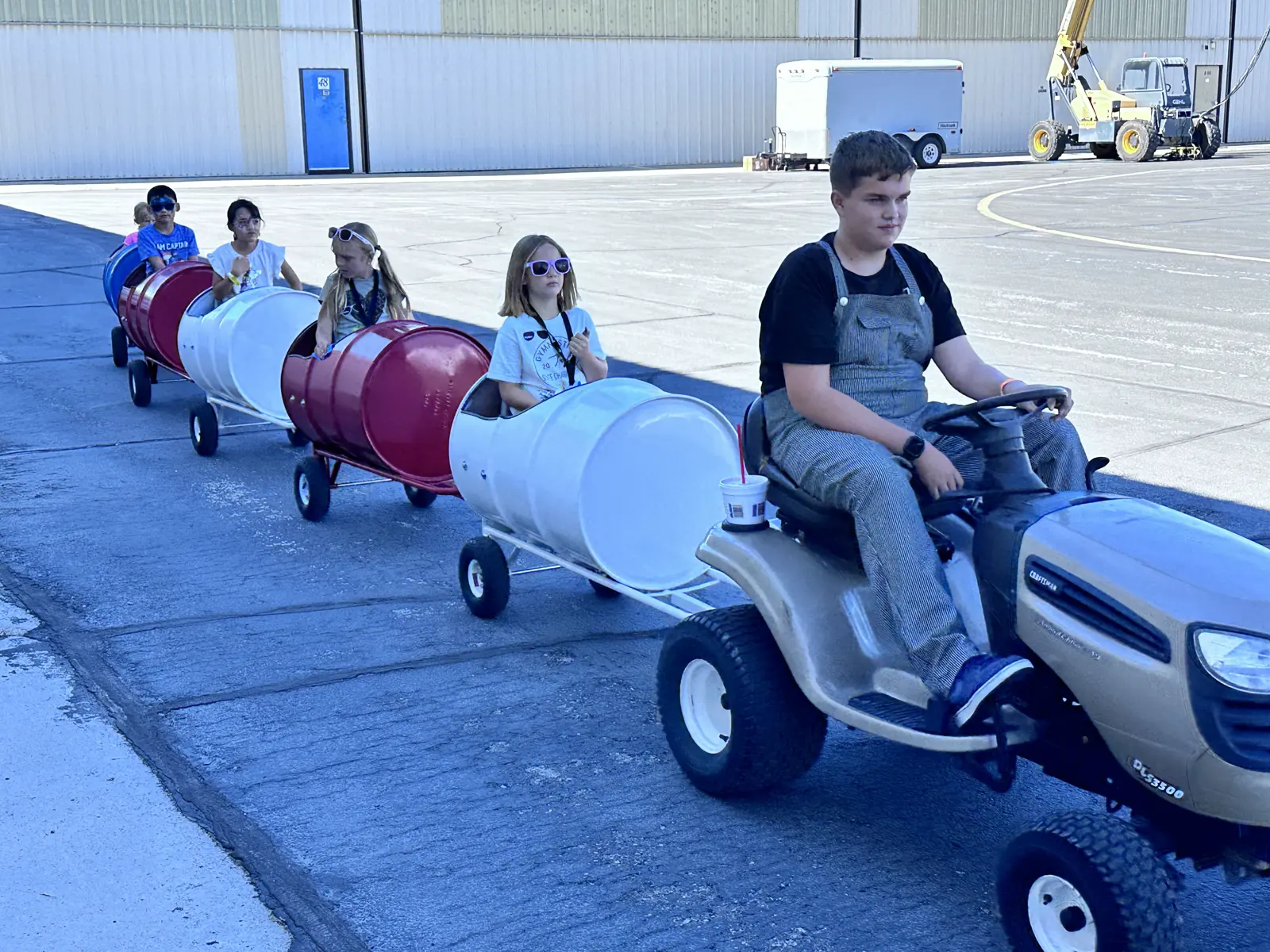 Kids riding the barrel train at the airshow